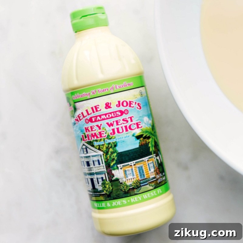 High-Quality Key Lime Juice for Authentic Flavor A bottle of key lime juice, highlighting the essential ingredient for this authentic Key Lime Pie recipe.