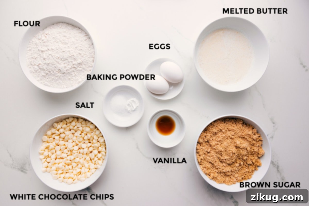 Ingredients In This Sugar Cookie Bars Recipe All the essential ingredients for this Sugar Cookie Bars Recipe are prepped and laid out, including flour, white chocolate chips, salt, baking powder, eggs, vanilla, melted butter, and brown sugar, ready for easy assembly.