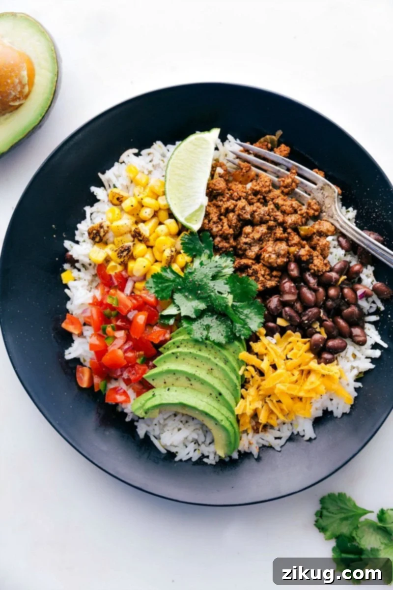 The Best Meal Prep: Taco Bowls A colorful and hearty Taco Bowl featuring seasoned ground beef, fluffy rice, black beans, fresh salsa, and a creamy drizzle, perfect for meal prep.