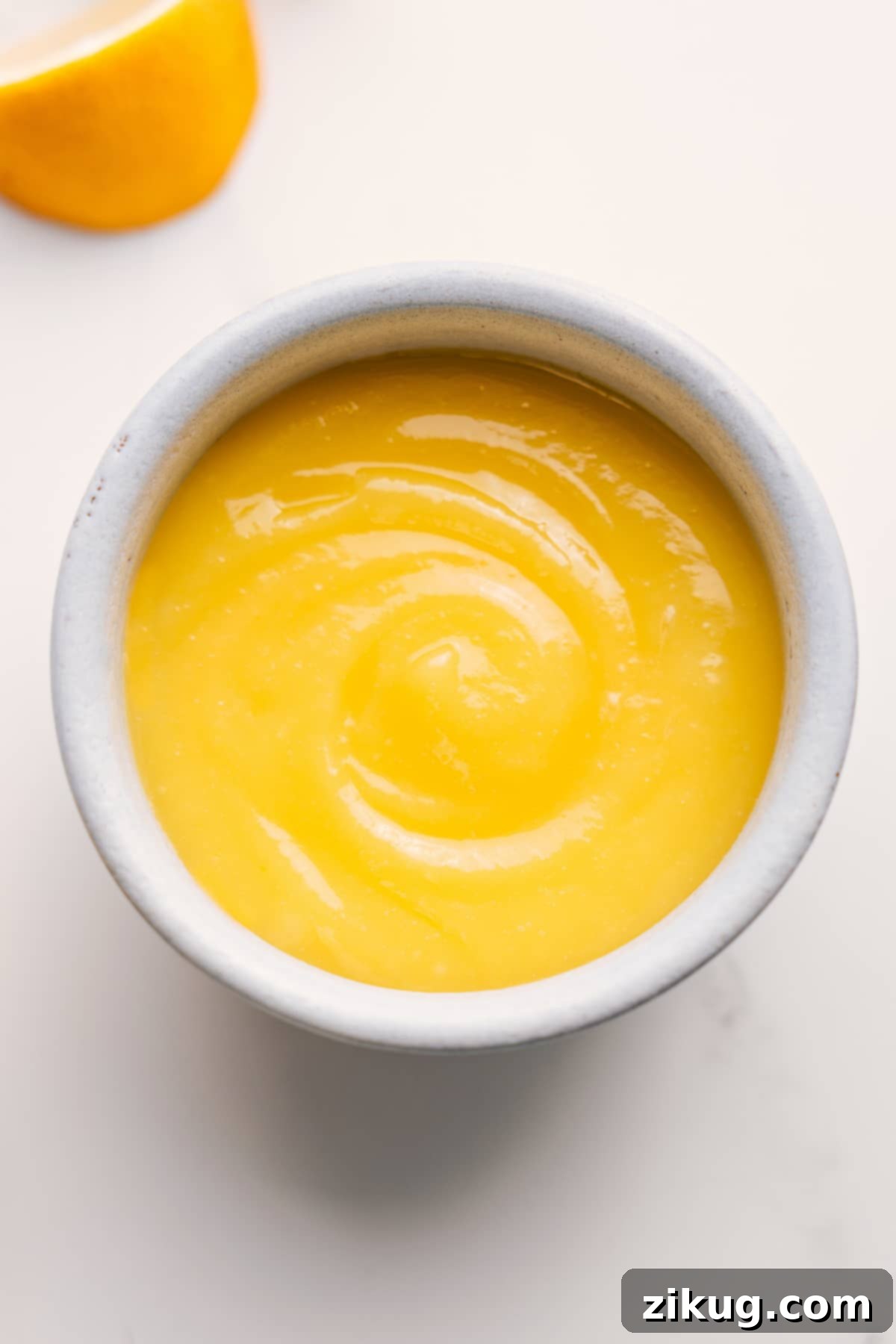 Fresh And Flavorful Lemon Curd Recipe A bowl of homemade lemon curd, garnished with fresh lemon zest, ready to be enjoyed.