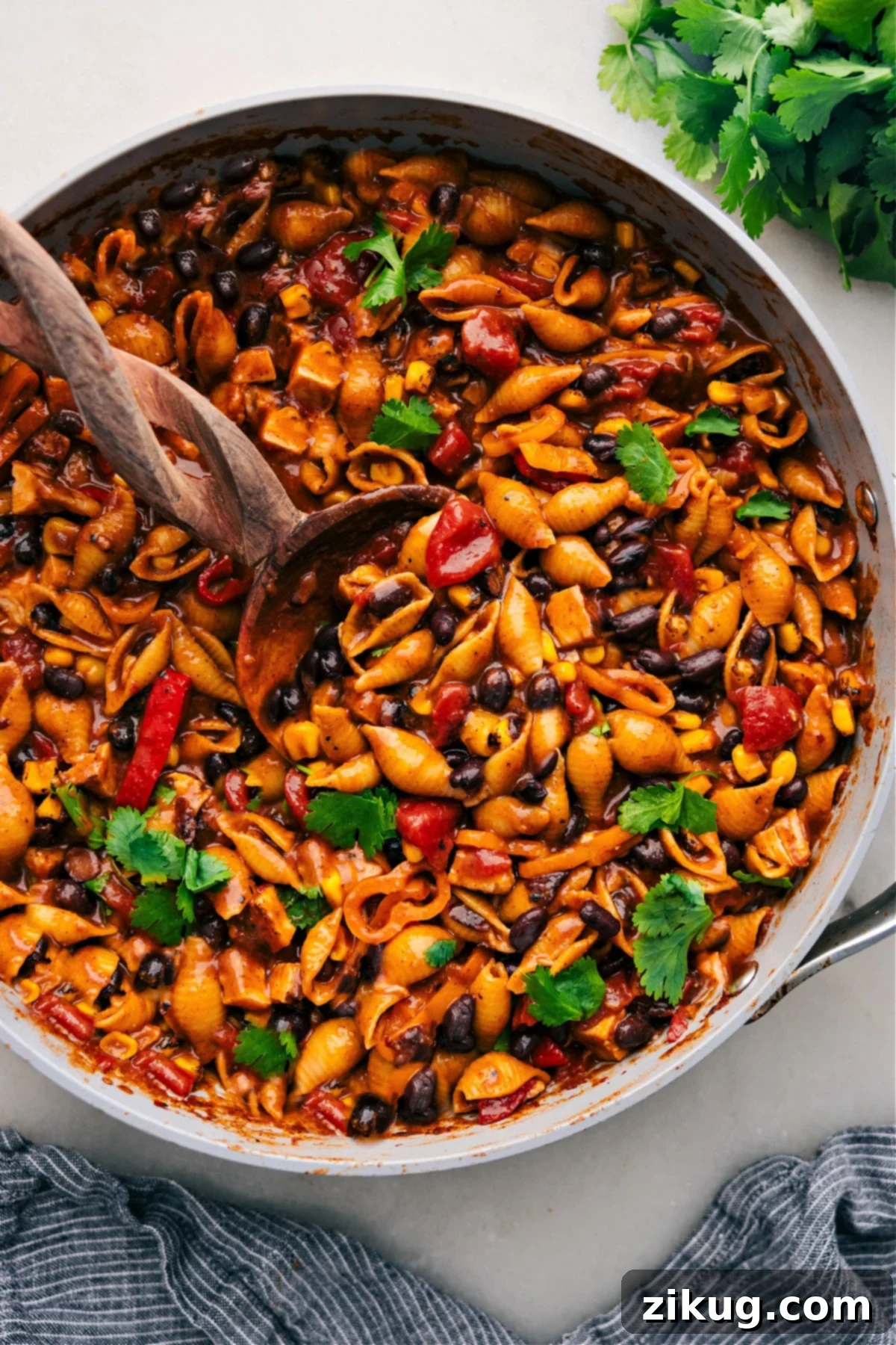 One Pot Enchilada Pasta for Quick Comfort Hearty One Pot Enchilada Pasta in a skillet, brimming with cheese, seasoned meat, and rich enchilada sauce, ready to be enjoyed.