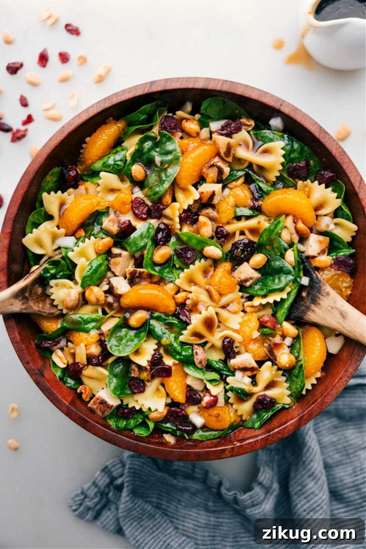 Refreshing Teriyaki Chicken Salad A vibrant Teriyaki Chicken Salad featuring pasta, fresh spinach, crunchy nuts, juicy oranges, water chestnuts, sweet onion, and tender chicken, all tossed in a simple 3-ingredient dressing.