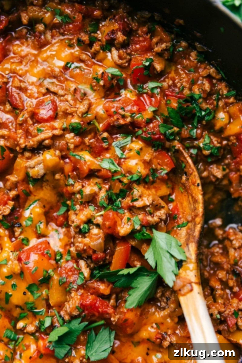 Unstuffed Peppers Recipes A pan full of delicious, savory unstuffed peppers, featuring seasoned meat and colorful peppers, garnished with fresh herbs.
