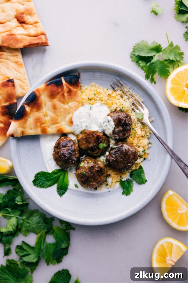 Beef Kofta Recipe On A Plate Beef kofta recipe, elegantly served with fresh mint yogurt sauce and an assortment of colorful veggies.