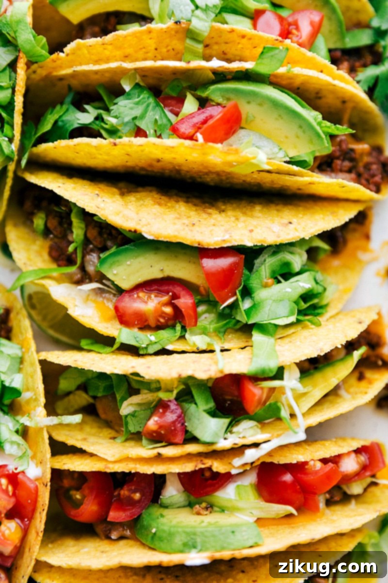Cajun Chicken In The Crockpot Delicious, savory ground beef tacos in a casserole dish, fully assembled with all the vibrant toppings, ready to be enjoyed.