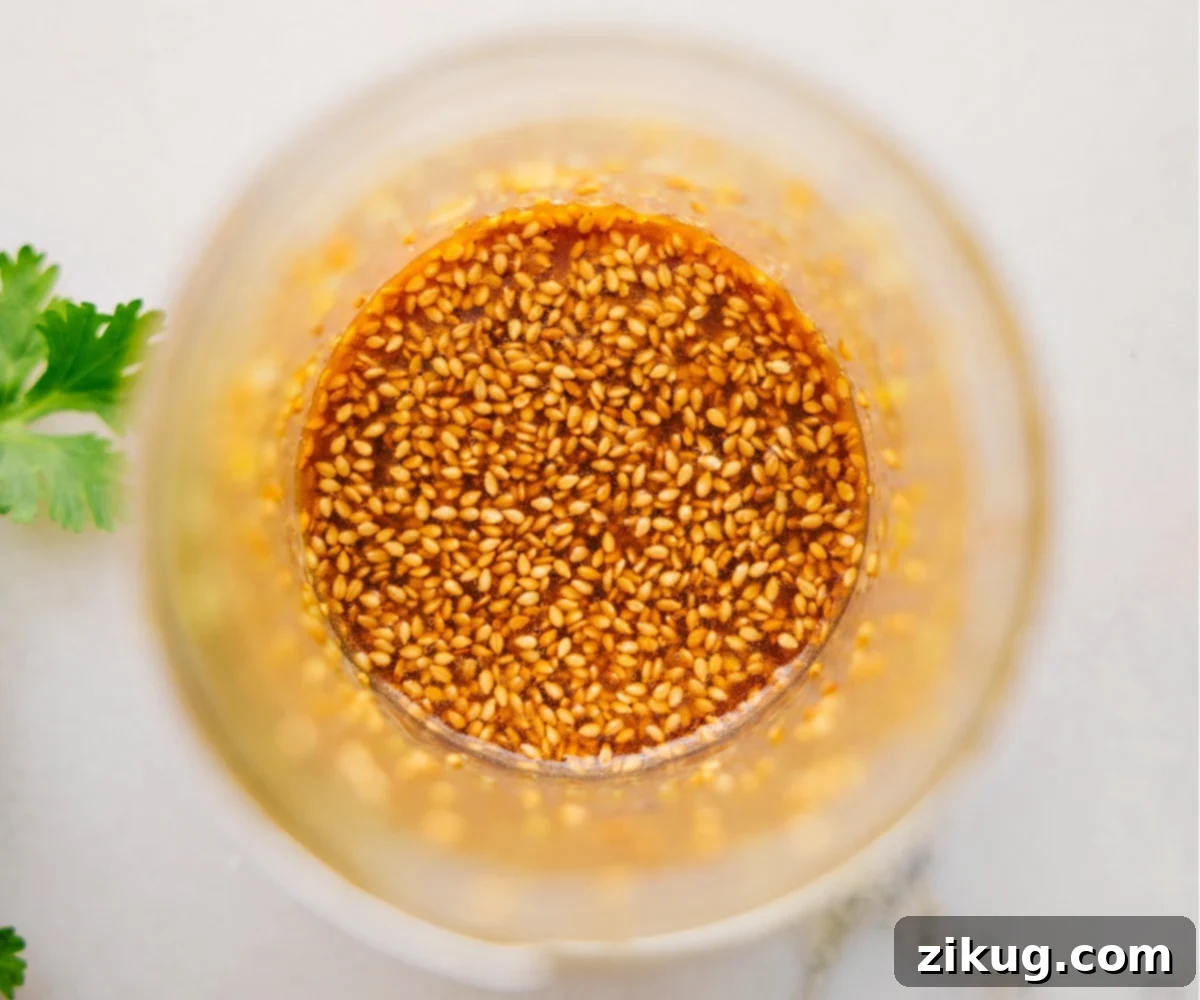 The Best Dressing For This Zesty Smashed Cucumber Salad The dressing all mixed together in a mason jar for this recipe.