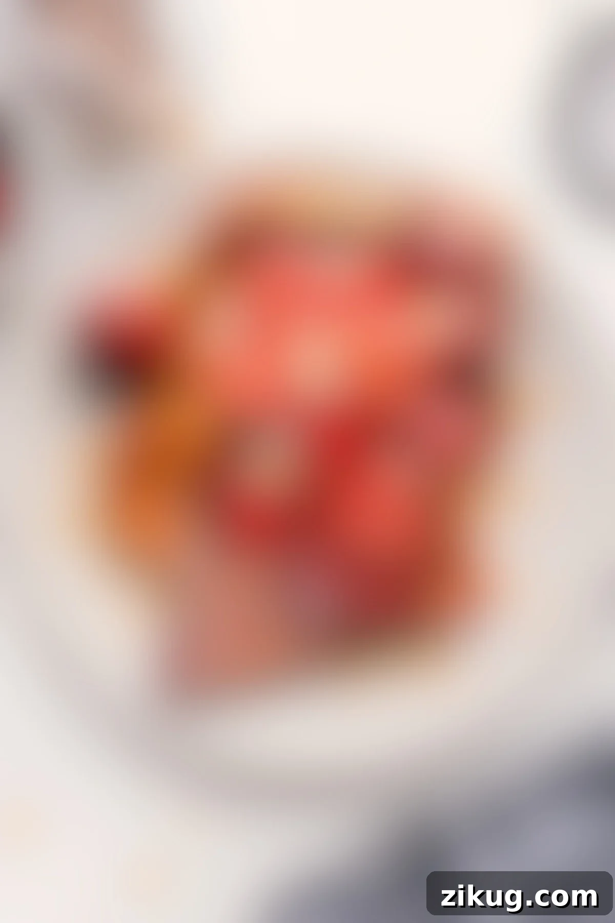 The Famous Kneader's French Toast Recipe A plate of Kneader's French toast copycat recipe, generously topped with fresh strawberries and rich maple syrup.