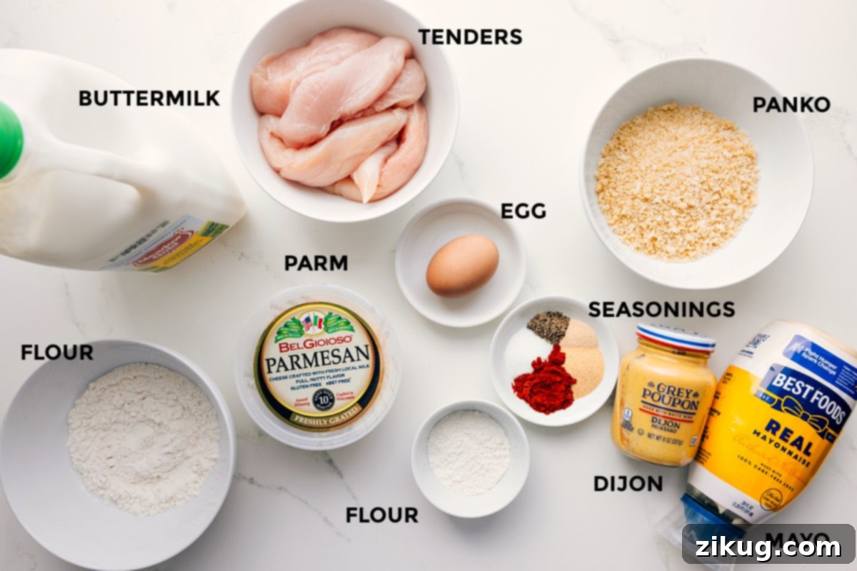 All the ingredients for Parmesan Chicken Tenders prepped out for easy assembly, including buttermilk, chicken, Parmesan, flour, seasonings, egg, Dijon mustard, mayonnaise, and Panko breadcrumbs.