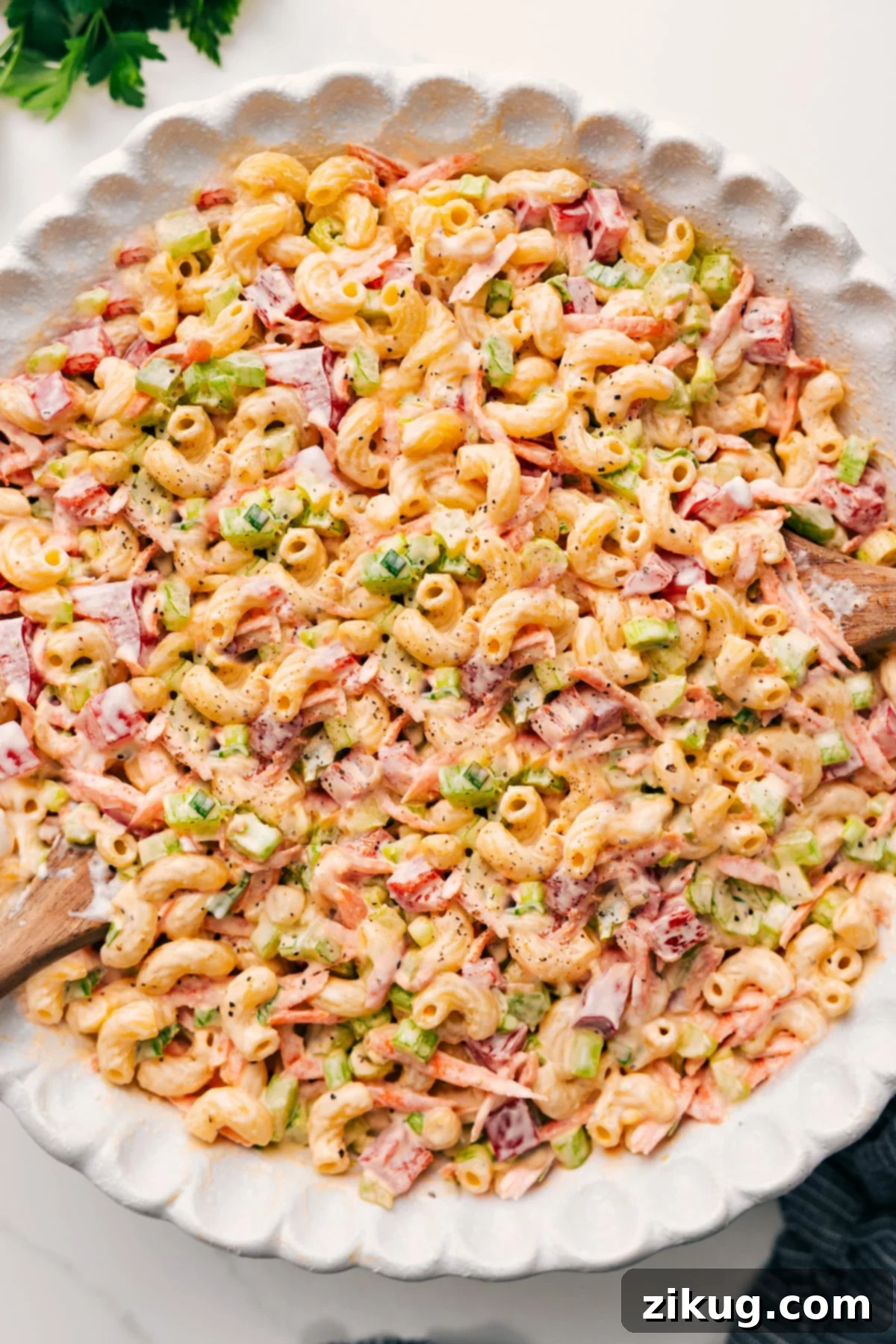 A vibrant bowl of Macaroni Salad, perfectly tossed and ready to be served, showcasing its creamy texture and colorful vegetables. This is the ultimate summer side dish.