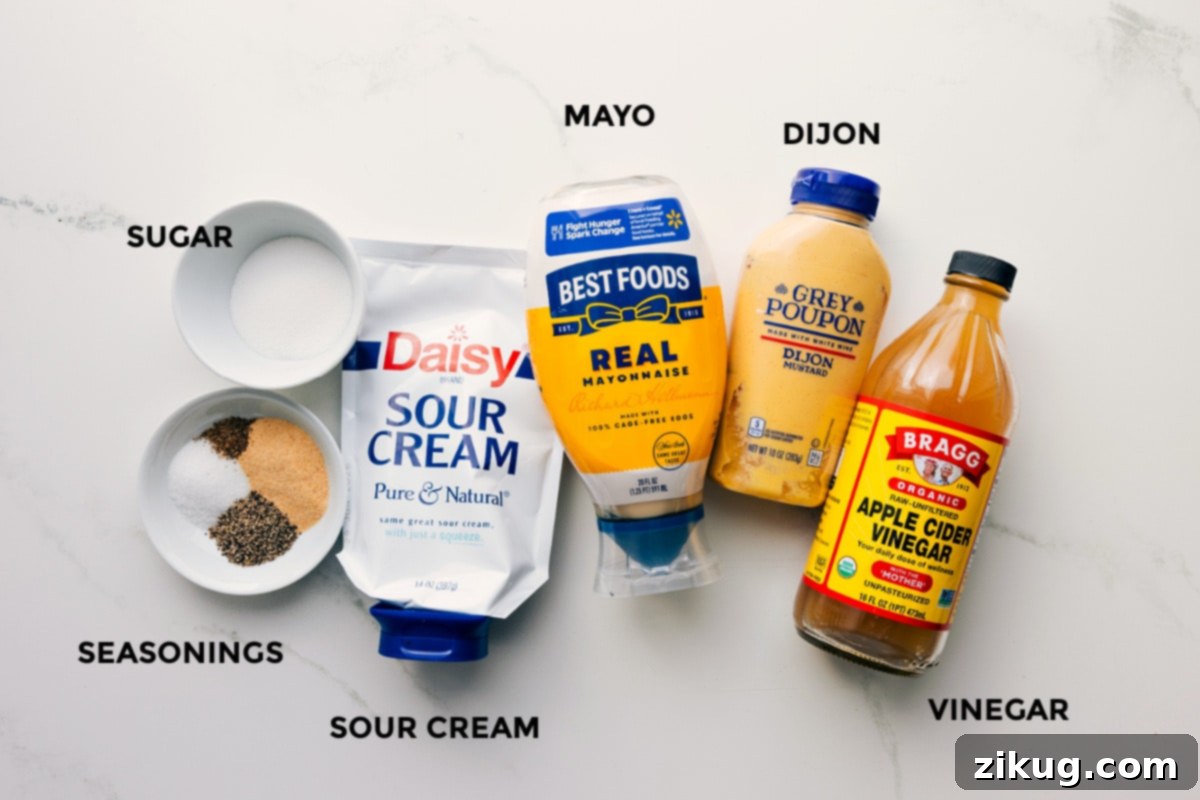 All the essential ingredients for the creamy and flavorful dressing of this Macaroni Salad Recipe, including mayonnaise, Dijon mustard, apple cider vinegar, granulated sugar, garlic powder, and celery seed, neatly arranged in small bowls for easy preparation.
