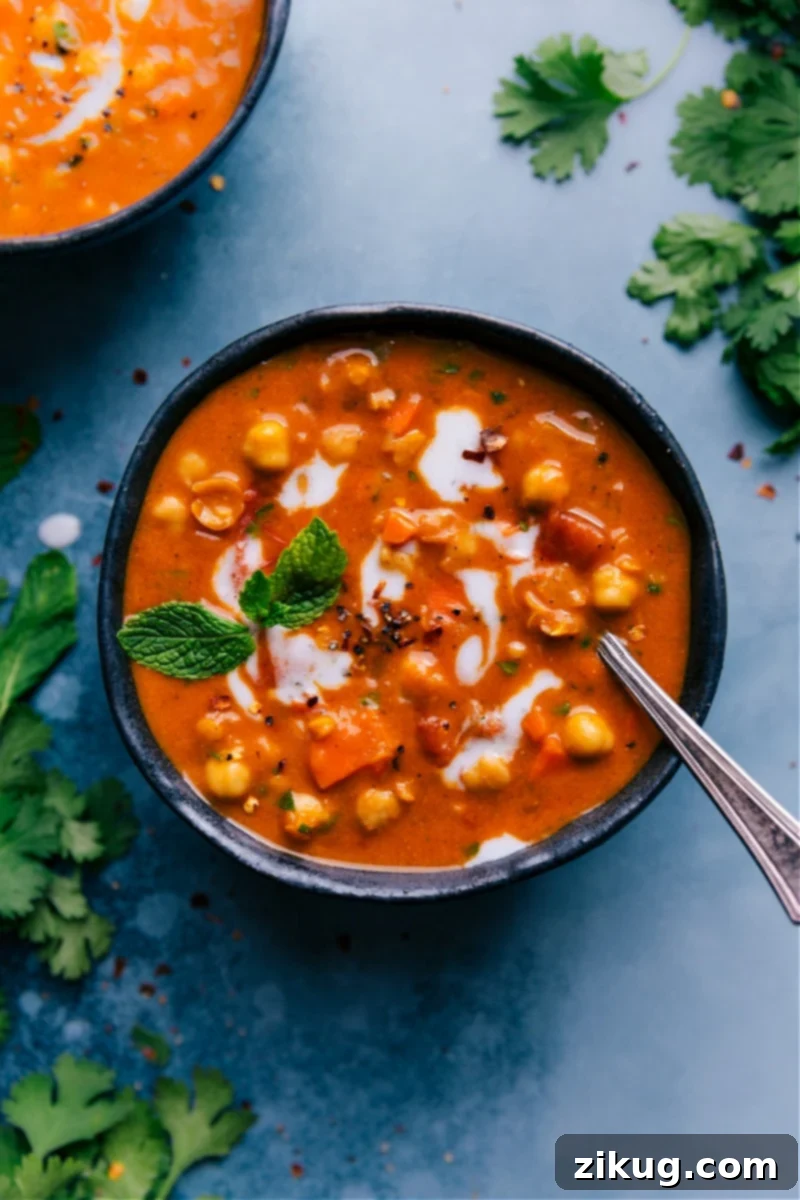 Comforting Vegan Chickpea Soup A warm bowl of vegan chickpea soup, topped with fresh mint, perfect for a comforting meal.