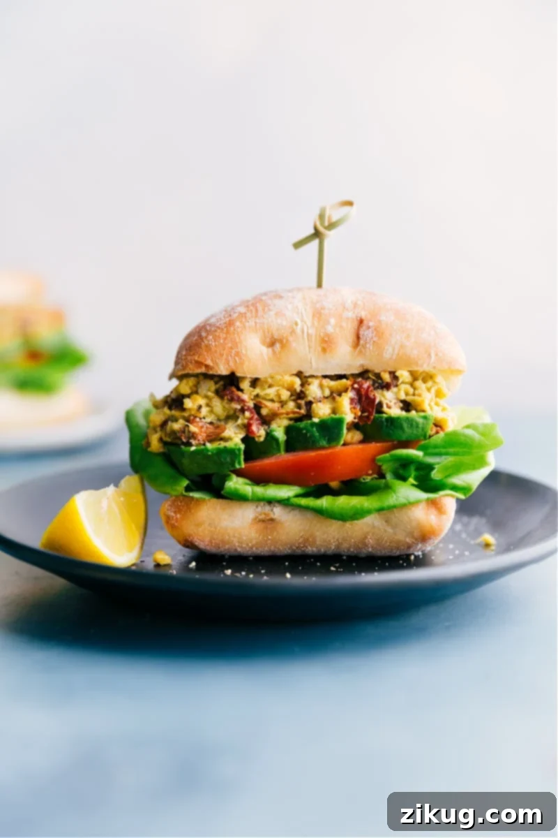 Quick Pesto Chickpea Sandwich A flavorful pesto chickpea sandwich on ciabatta bread, filled with mashed chickpeas, sun-dried tomatoes, avocado, and fresh lettuce.