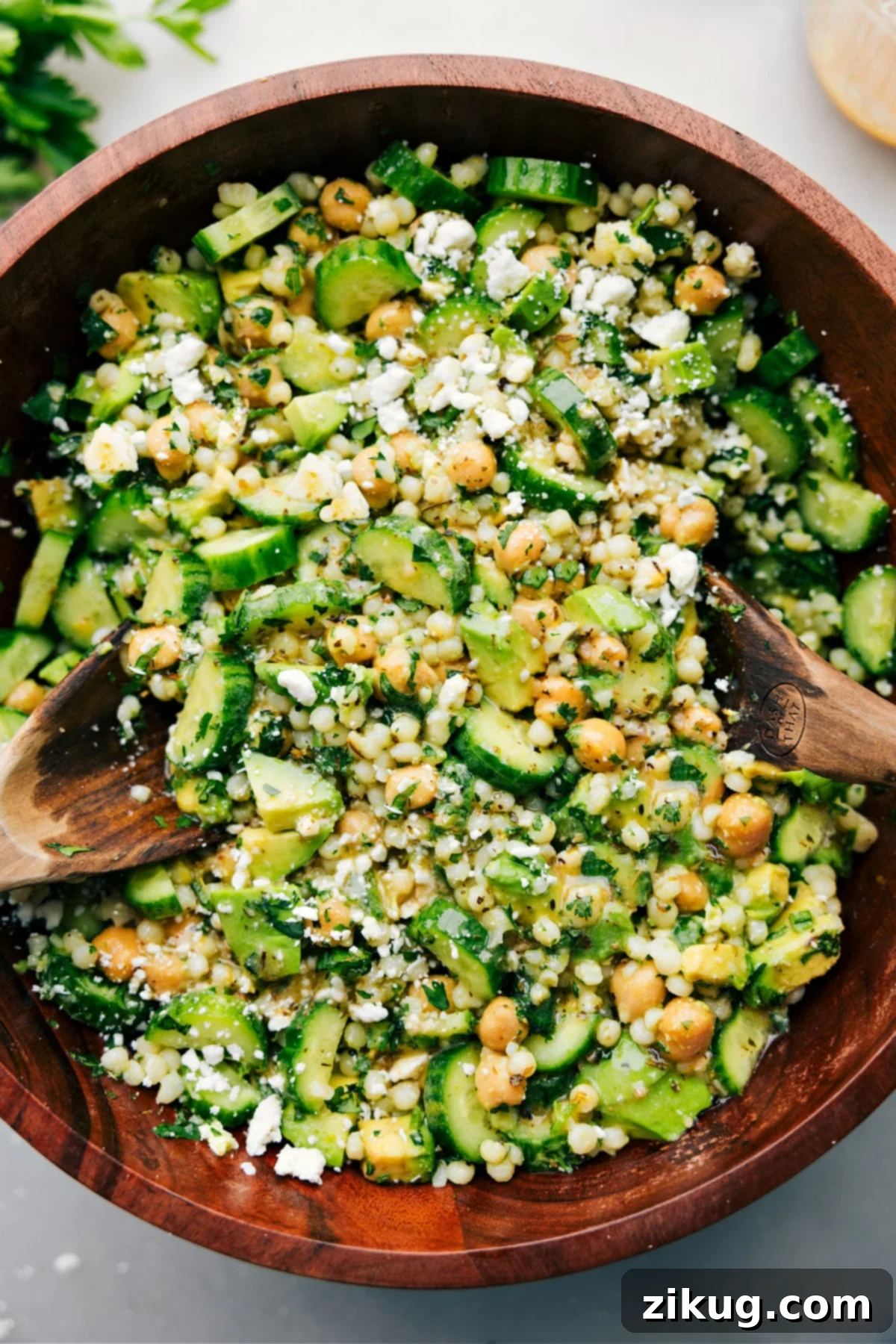 Fresh Cucumber Feta Salad A refreshing cucumber feta salad tossed with couscous, chickpeas, and a bright lemon dressing, ready to be served.