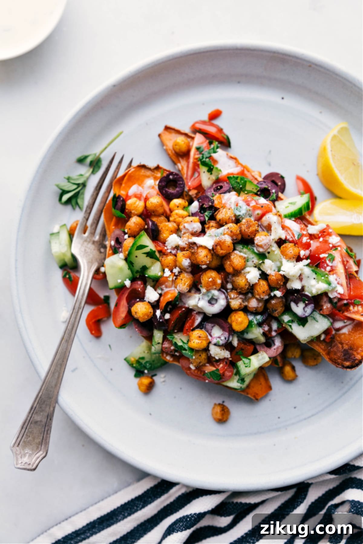 Mediterranean Sweet Potatoes with Chickpeas Flavorful Mediterranean sweet potatoes topped with crispy chickpeas and a creamy dressing, making a wholesome and delicious meal.