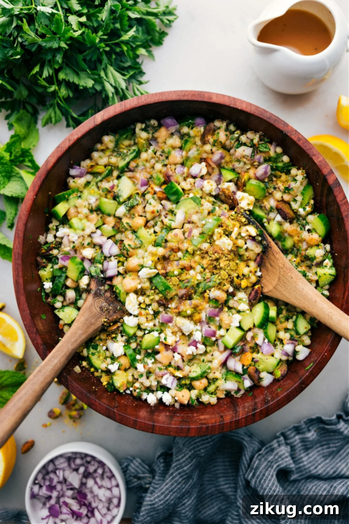 The Viral Jennifer Aniston Salad The famous Jennifer Aniston Salad in a large bowl, dressed and ready to be enjoyed, featuring chickpeas, herbs, and feta cheese.