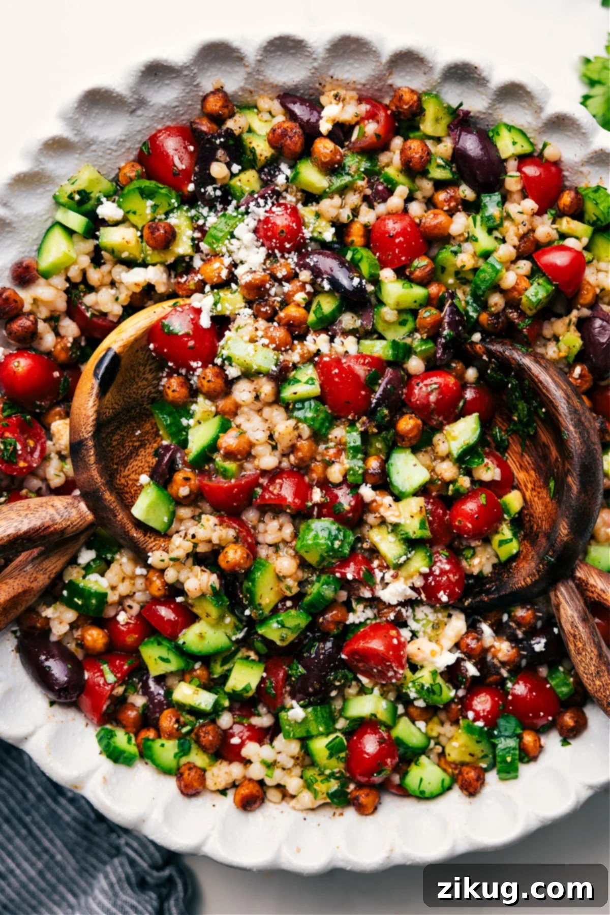 Refreshing Chickpea Salad A fresh and vibrant chickpea salad filled with colorful vegetables and a zesty lemon dressing in a large bowl.
