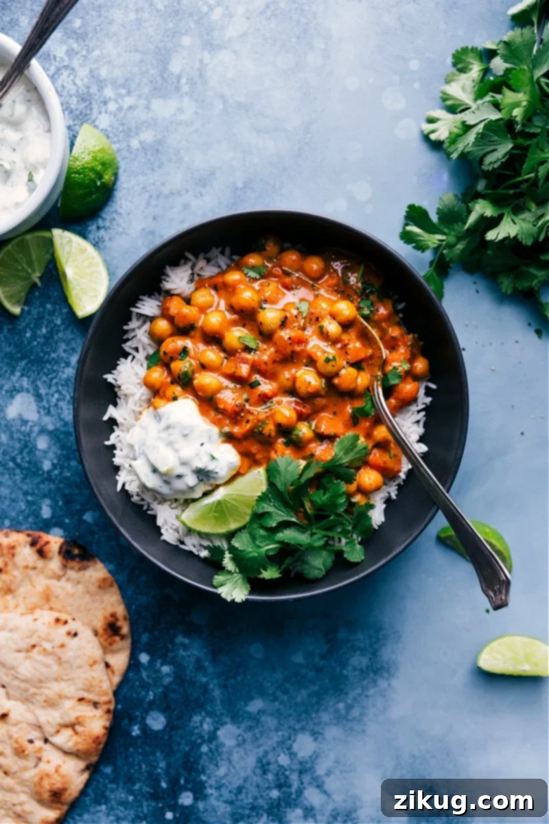 Flavorful Chickpea Curry A rich and creamy chickpea curry served in a bowl, garnished with fresh cilantro and lime wedges.