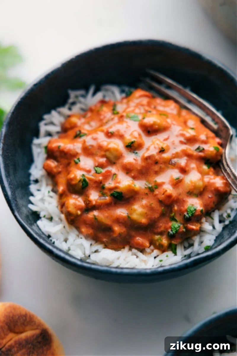 Creamy Butter Chickpeas A delicious bowl of Butter Chickpeas, a plant-based twist on butter chicken, served over rice.