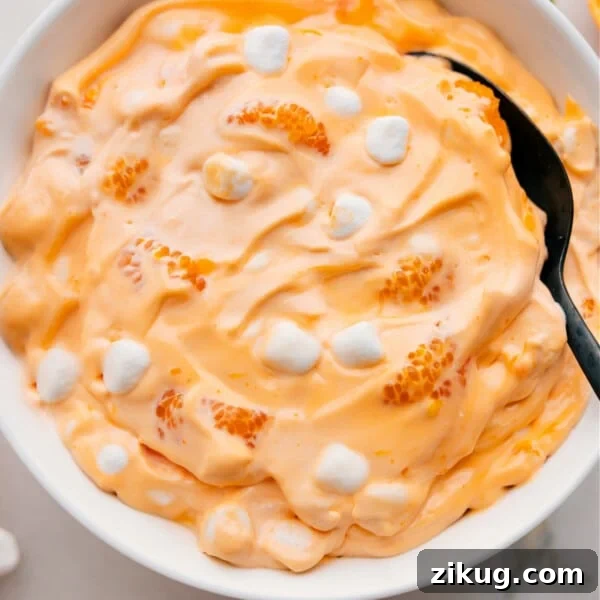 Homemade Cosmic Brownies Recipe with Fudgy Chocolate Filling 5 Orange Fluff Salad in a large bowl.