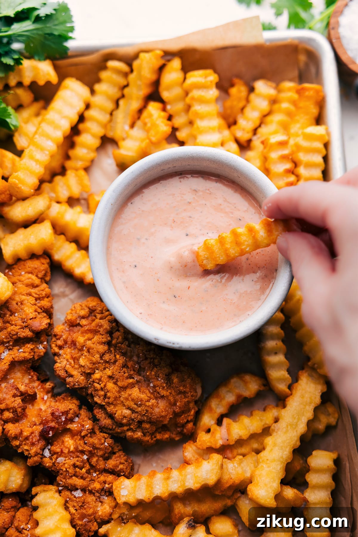 Cane's Sauce Recipe Cane’s sauce recipe in a bowl with a fry dipping into it.