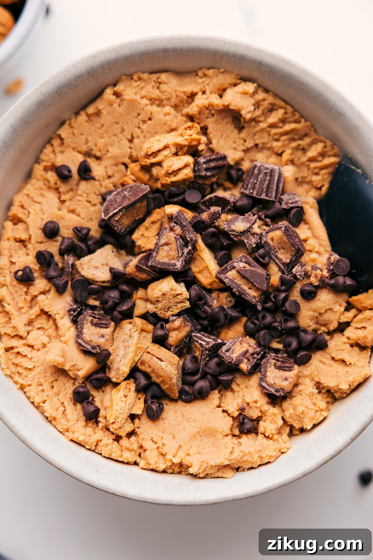 Peanut Butter Edible Cookie Dough Peanut Butter Edible Cookie Dough in a bowl topped with peanut butter cups and Nutter Butters.