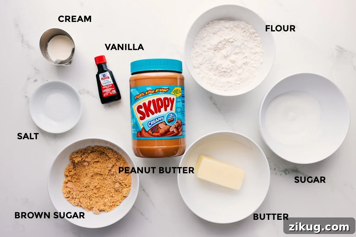 Ingredients In Peanut Butter Edible Cookie Dough All the ingredients in this recipe prepped out for easy assembly including the cream, vanilla, salt, brown sugar, peanut butter, flour, sugar, and butter.