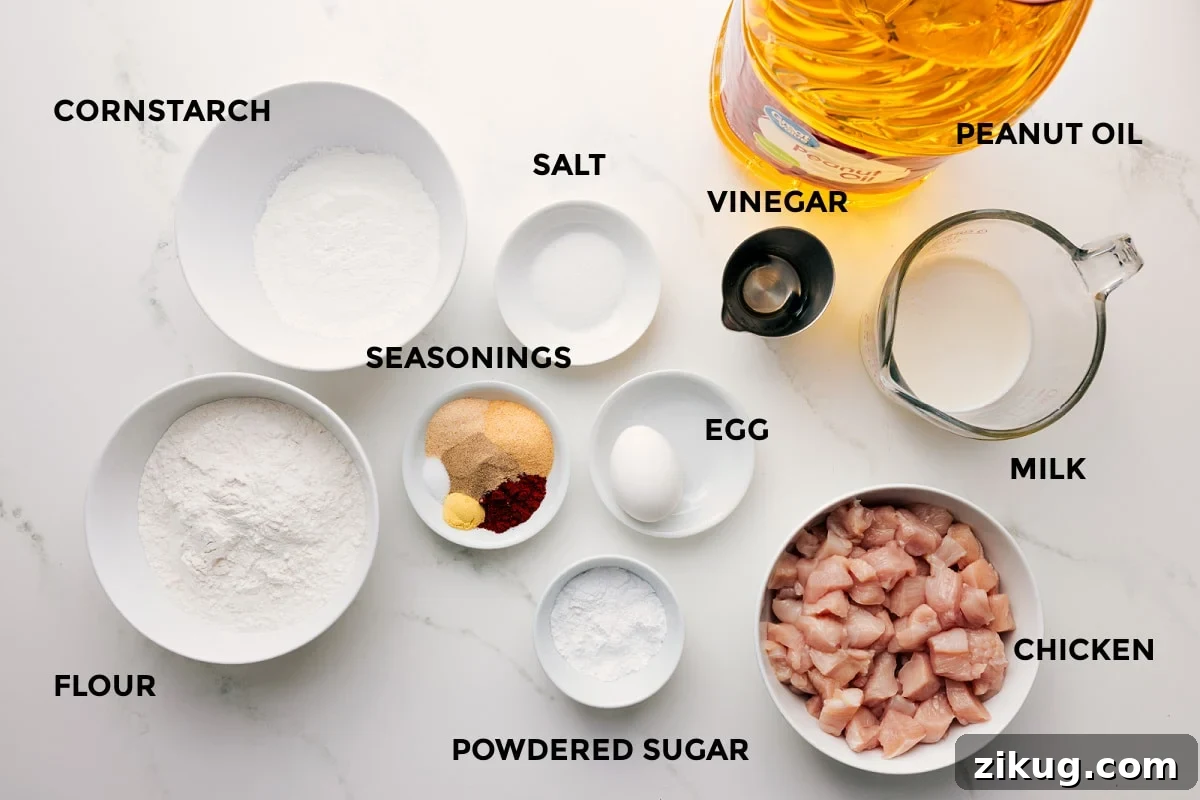 Ingredients In Chick-Fil-A Nuggets Recipe All the ingredients in this recipe prepped out for easy assembly including the cornstarch, flour, seasonings, salt, powdered sugar, egg, vinegar, peanut oil, milk, and chicken.