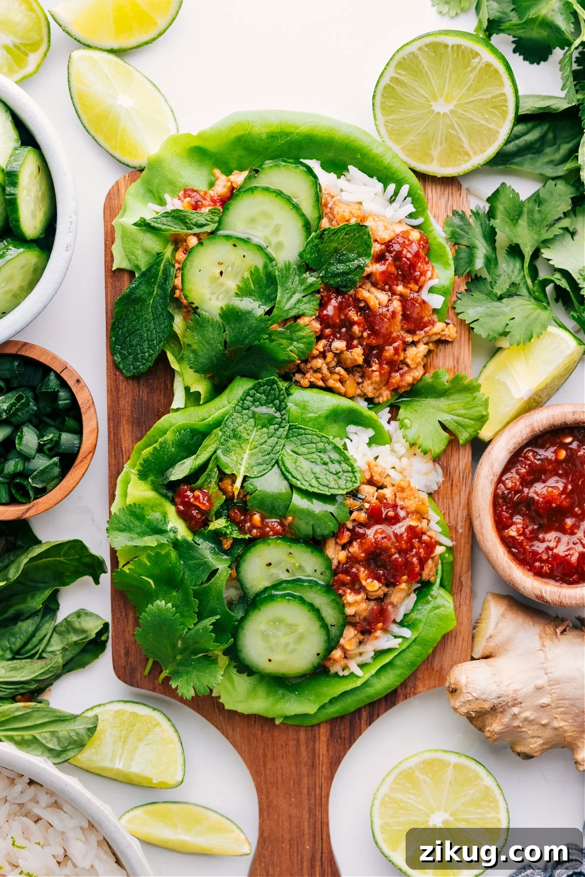 Chicken Larb Recipe Asian Chicken Recipes: Chicken larb served in lettuce wraps with cucumbers and parsley on top.