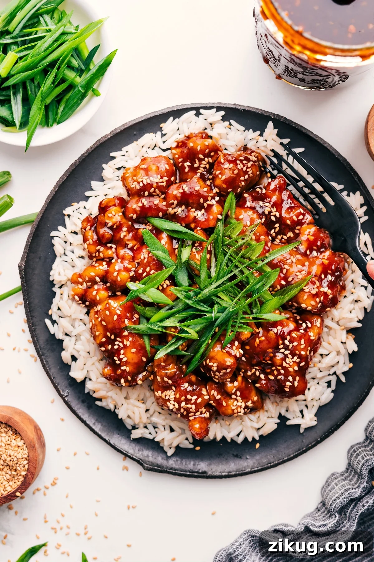 Korean Chicken Recipe Asian chicken recipes: Korean chicken served over rice and topped with sliced green onions.