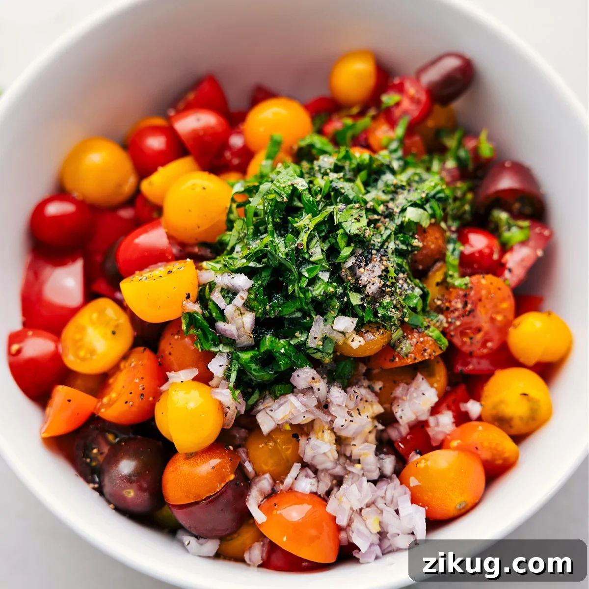 How To Make A Tomato Salad All the ingredients in this cherry tomato salad recipe in a bowl ready to be tossed together.