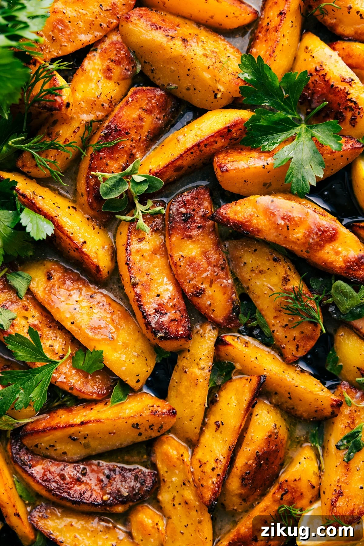 Greek Potatoes Recipe Greek recipes: Greek potatoes recipe on a tray with fresh herbs.