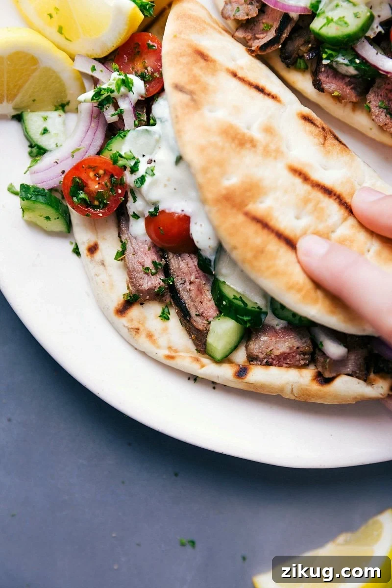 Steak Gyros Greek recipes: Steak gyros fully stuffed with succulent meat, fresh vegetables, and a delicious sauce, ready to be eaten.