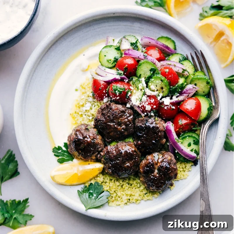 Greek Meatball Bowls Meatball bowls filled with juicy meatballs, fluffy couscous, cucumber tomato salad, and a creamy lemon herb sauce.