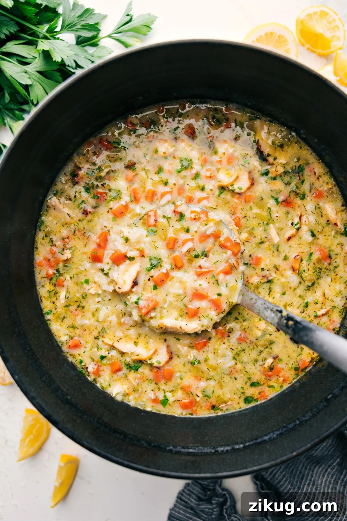 Greek Lemon Soup Recipe Lemon soup in the pot with a big ladle full coming out.