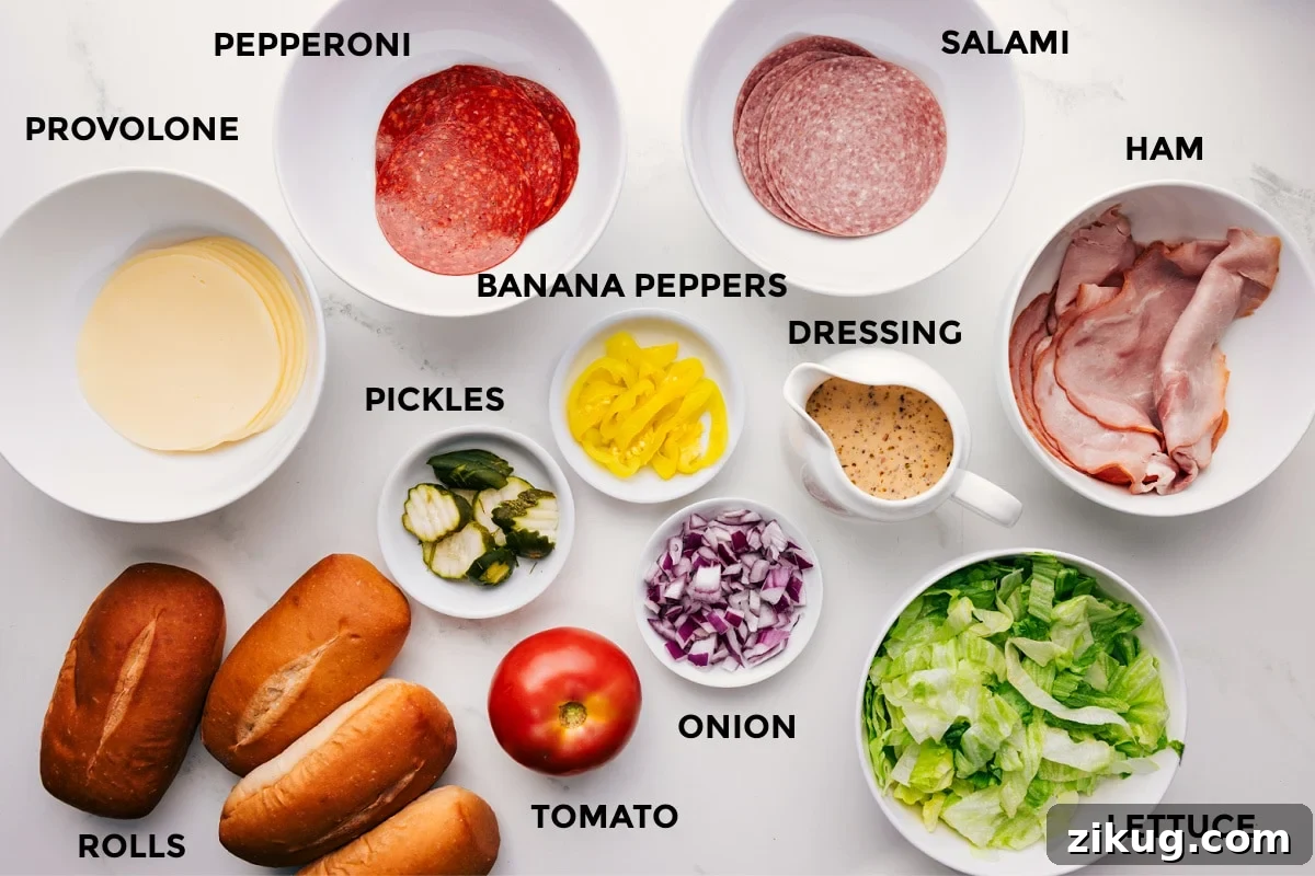 Ingredients In This Chopped Italian Sandwich All the ingredients in this recipe prepped out for easy assembly including provolone, pepperoni, salami, ham, rolls, pickles, banana peppers, tomato, onion, dressing, and lettuce.
