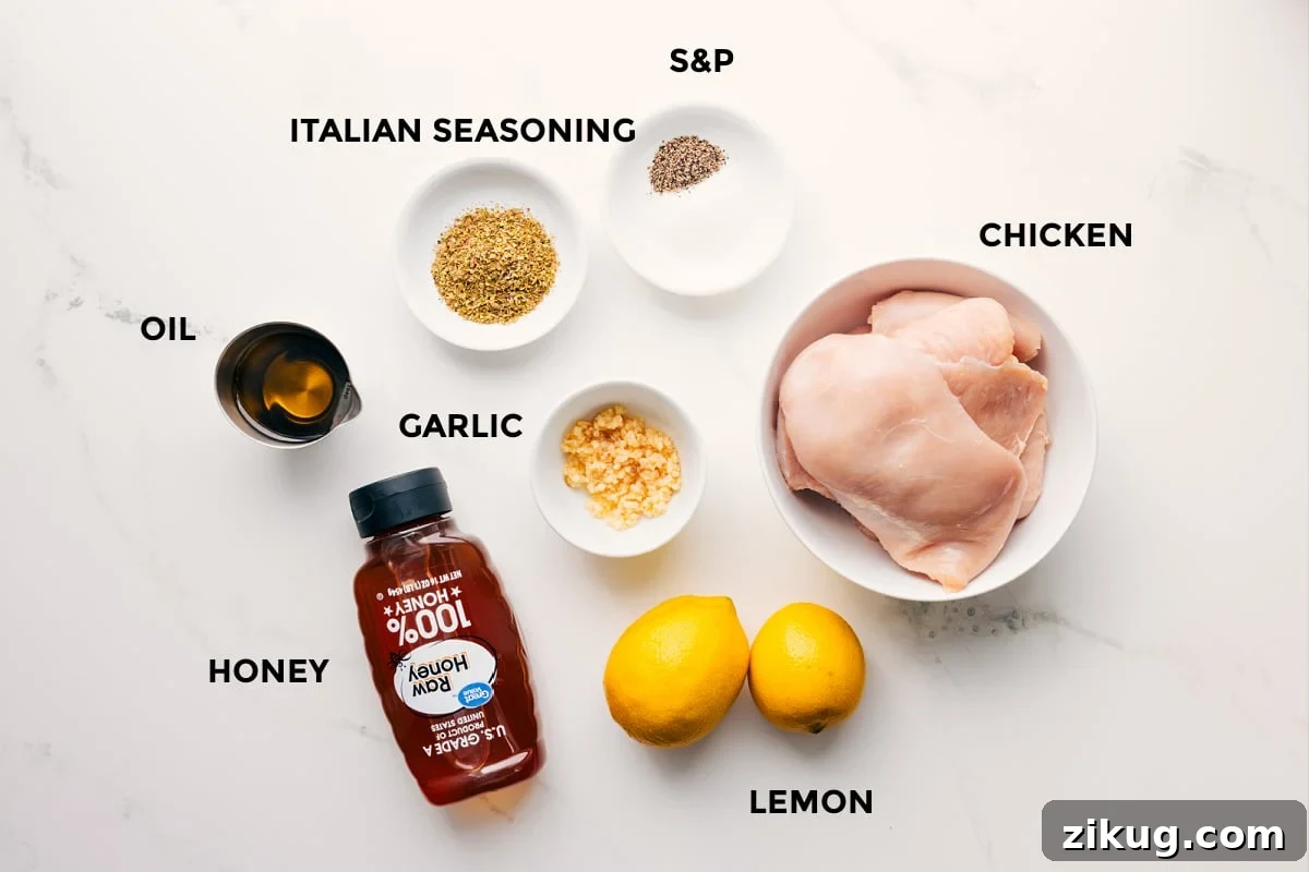 Lemon Garlic Chicken Marinade Ingredients The ingredients in this recipe prepped out for easy assembly including the oil, honey, seasonings, garlic, chicken, and lemons.