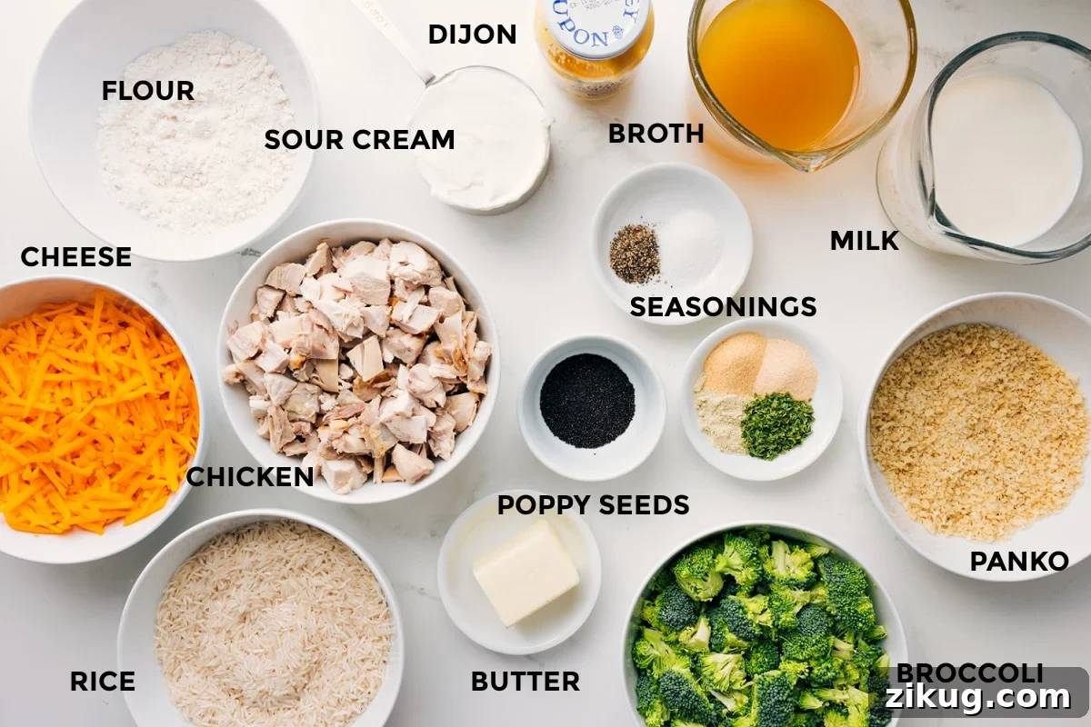 Ingredients In This Poppy Seed Chicken Casserole Ingredients for Poppy Seed Chicken Casserole prepped for assembly, including cheese, rice, chicken, broccoli, panko, and sauce ingredients.