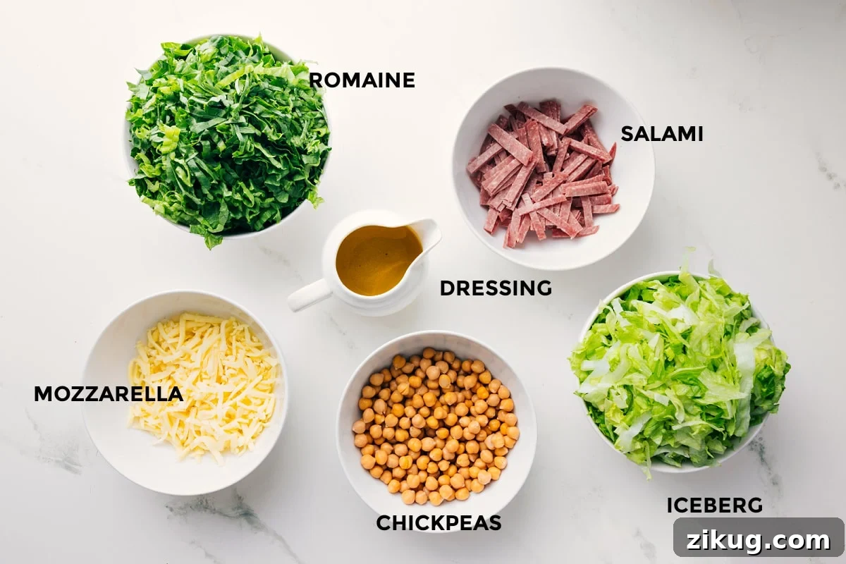 Ingredients In La Scala Chopped Salad All the ingredients in this recipe prepped out for easy assembly including the romaine, mozzarella, salami, iceberg, chickpeas, and dressing.