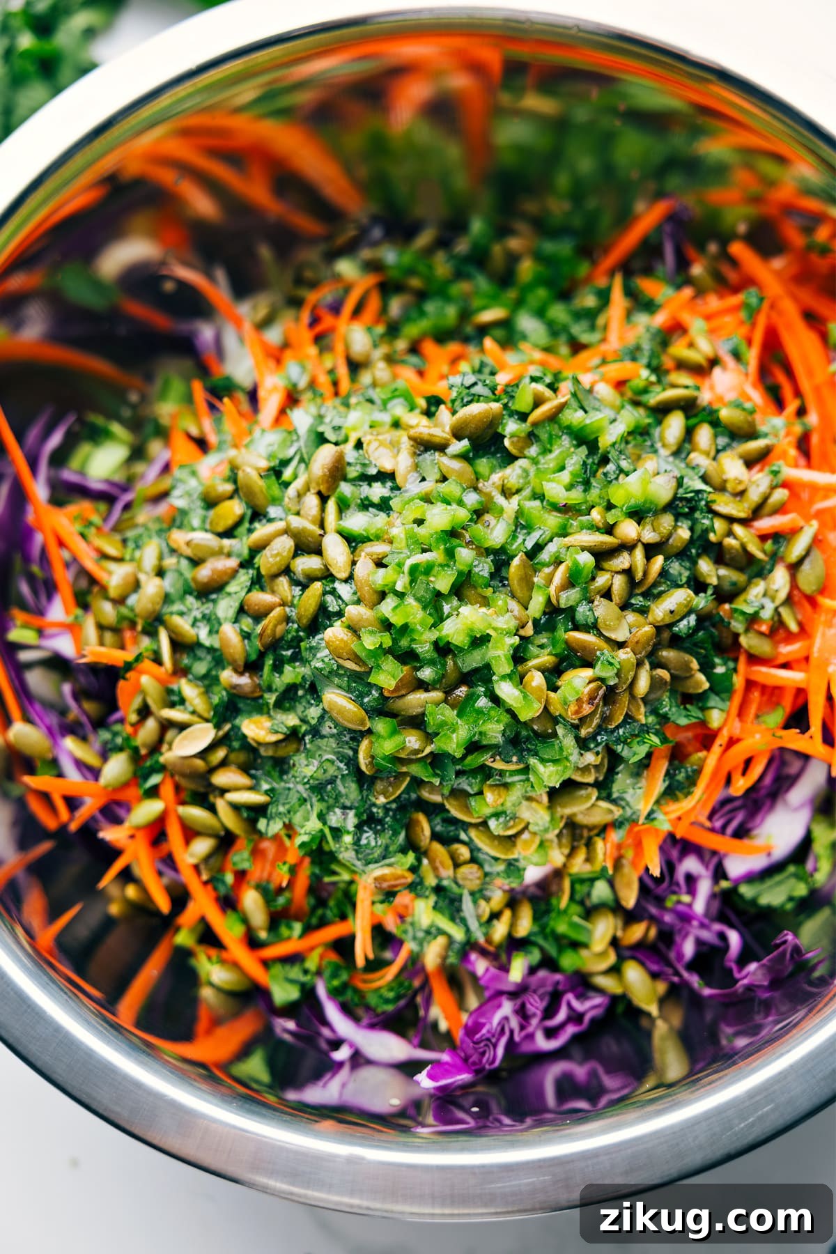 How To Make This Healthy Slaw Healthy Slaw ingredients in a large bowl with the dressing poured over the top, ready to be tossed together.