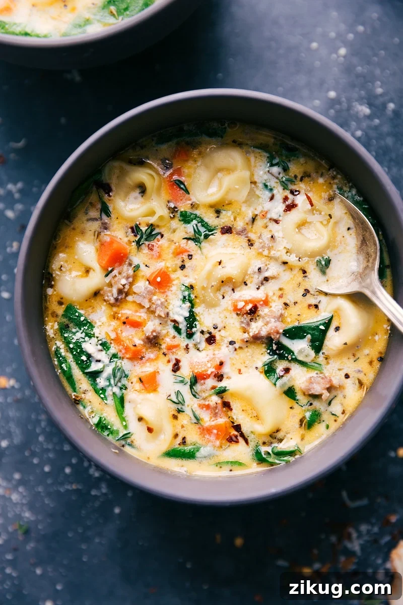 Italian Sausage Tortellini Soup Sausage Tortellini Soup in a bowl with a spoon in it.