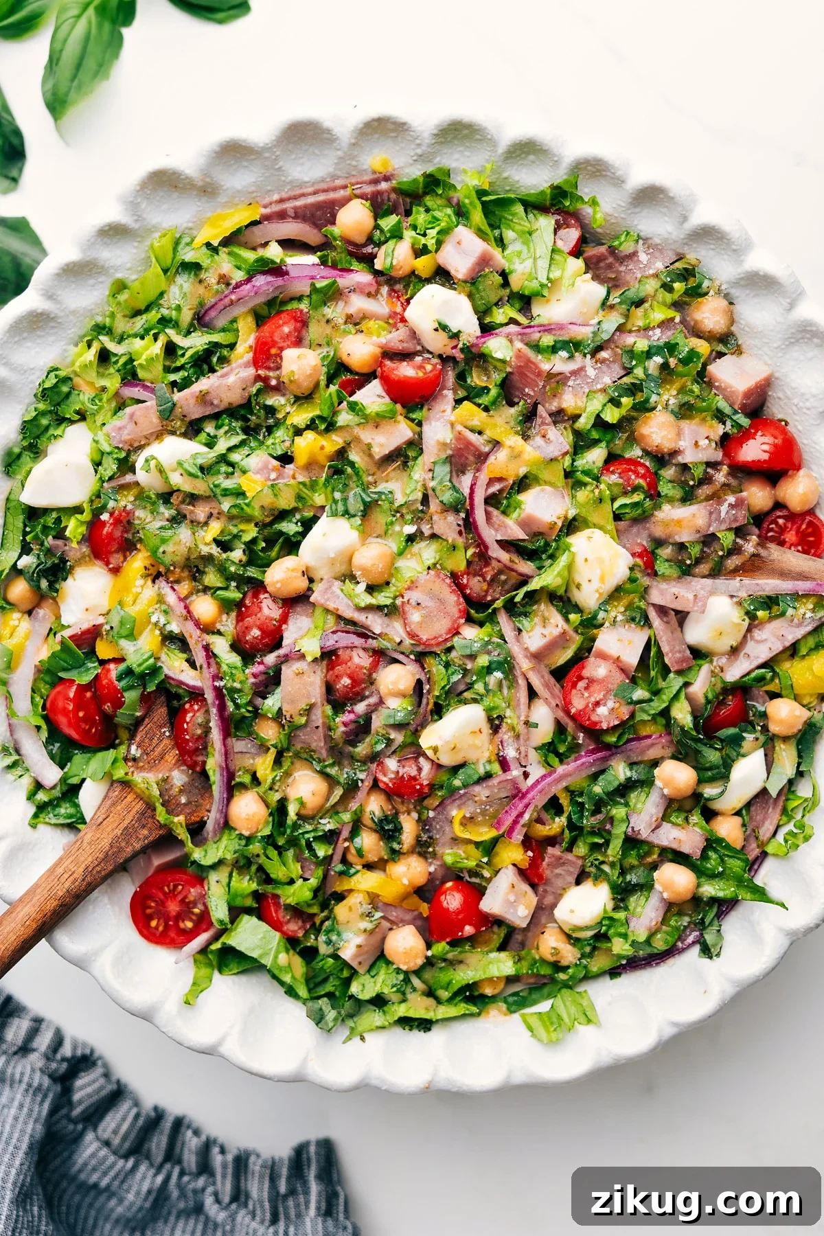 Italian Chopped Salad Fresh chopped salad loaded with salami, ham, chickpeas, mozzarella, pepperoncini, basil, and lemon dressing.