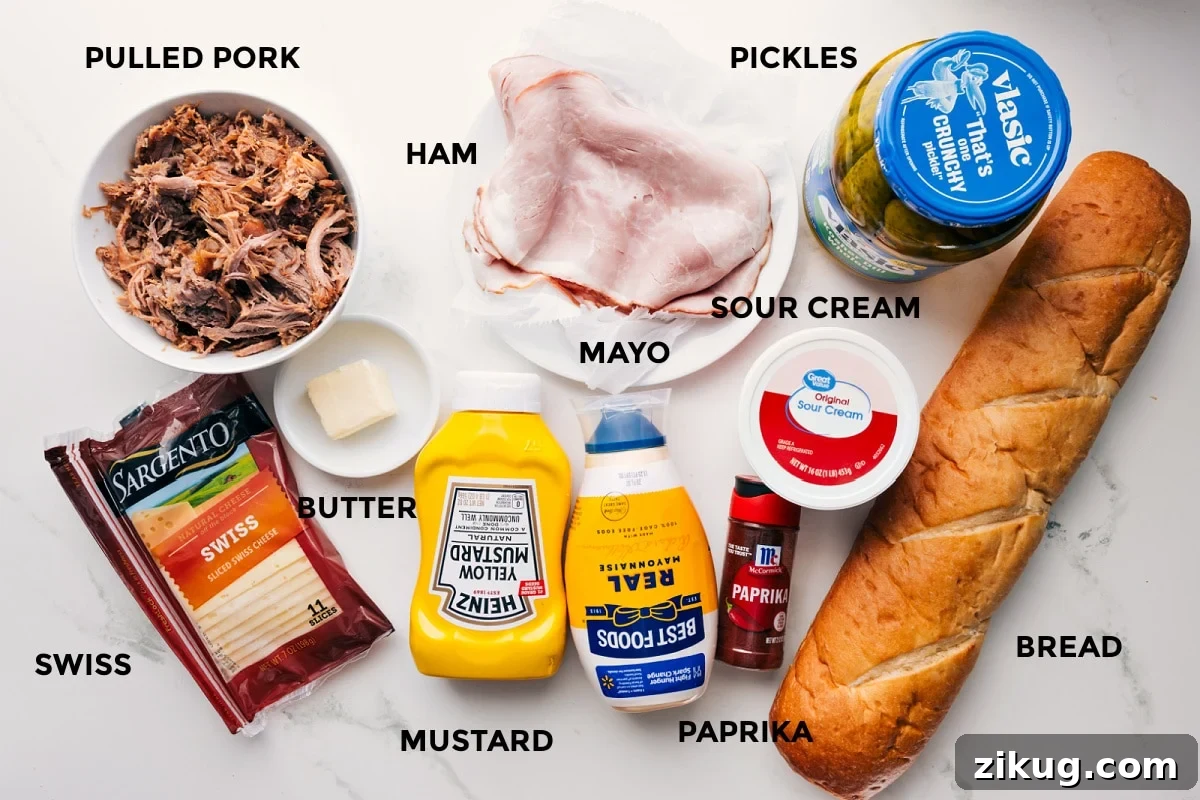 Ingredients In Cuban Sandwich Recipe Ingredients in this recipe prepped out for easy assembly including the pulled pork, swiss, butter, ham, mustard, paprika, sour cream, bread, and pickles.