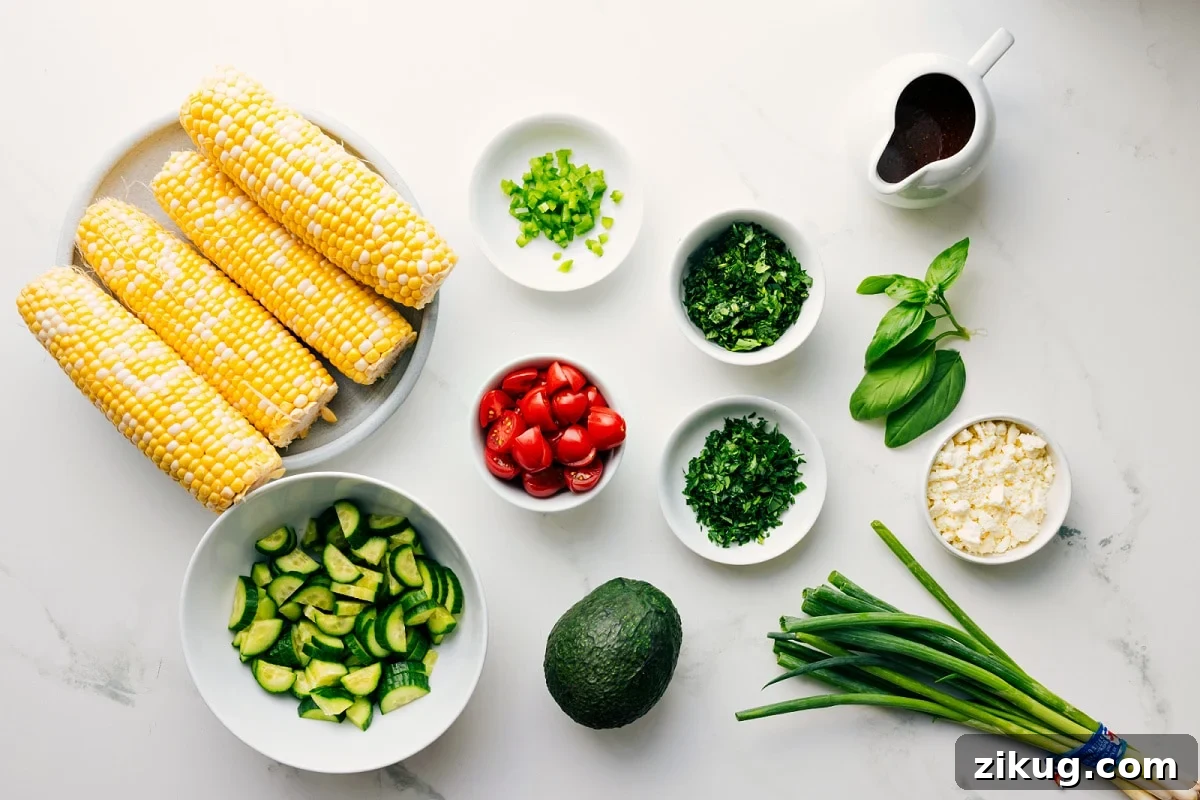 Ingredients In This Corn Salad Recipe All the ingredients in this recipe prepped out for easy assembly including the corn, cucumbers, avocado, tomatoes, jalapeños, cilantro, parsley, basil, green onions, feta, and vinaigrette.