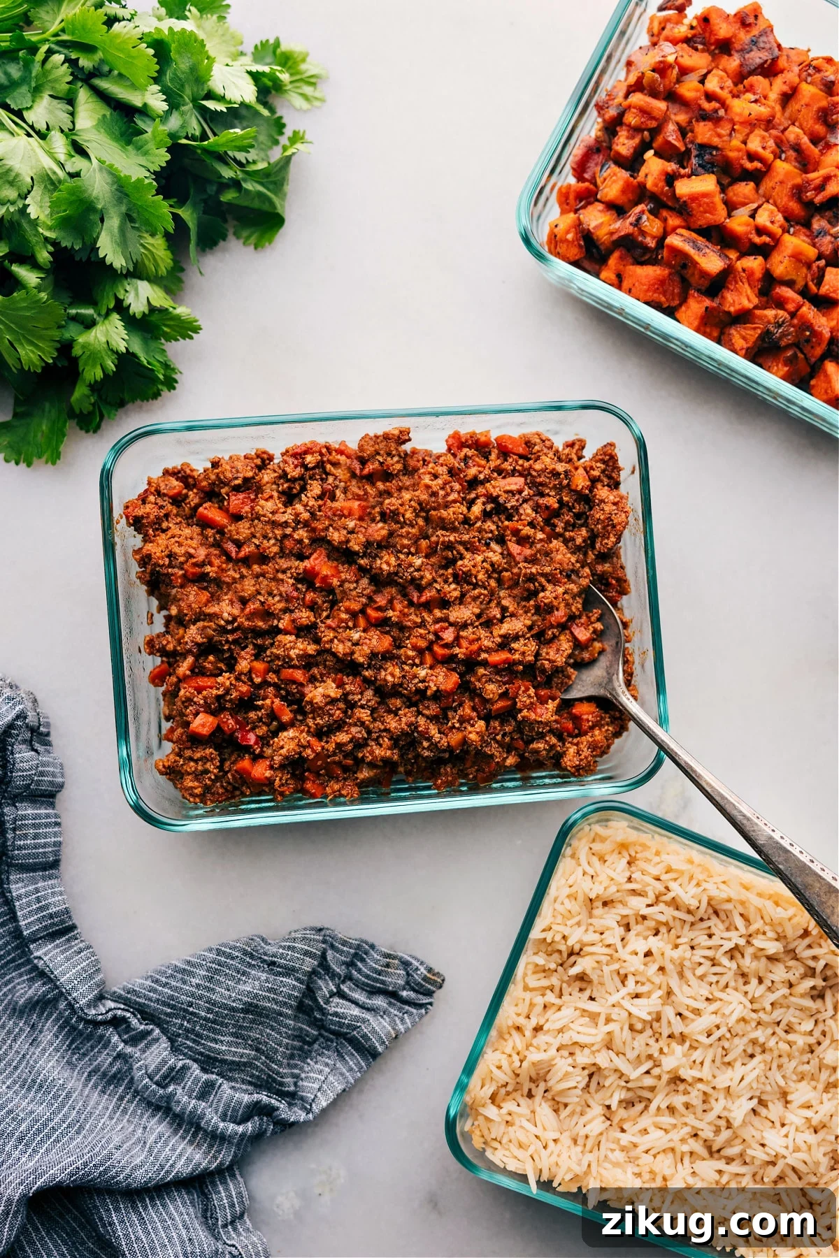 Cajun Chicken In The Crockpot Ground turkey served over rice in individual meal prep containers.