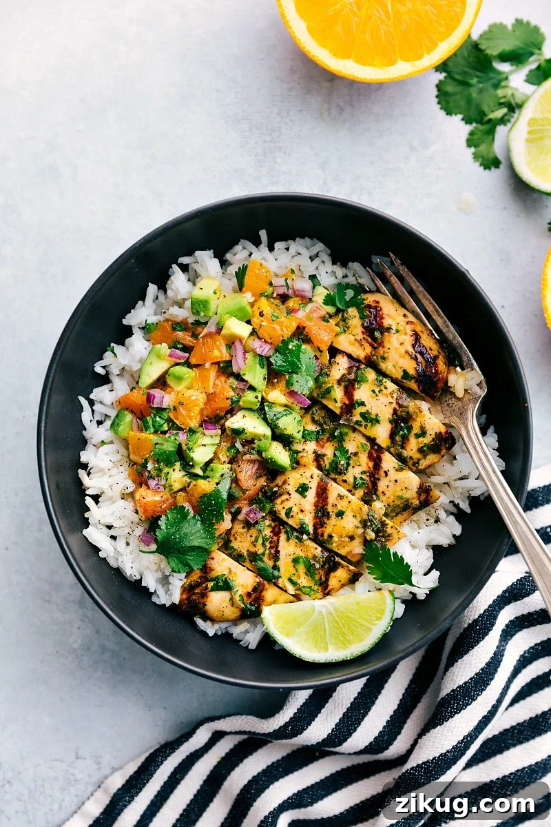 Cuban Mojo Chicken Cuban mojo chicken over rice with citrus avocado salsa.