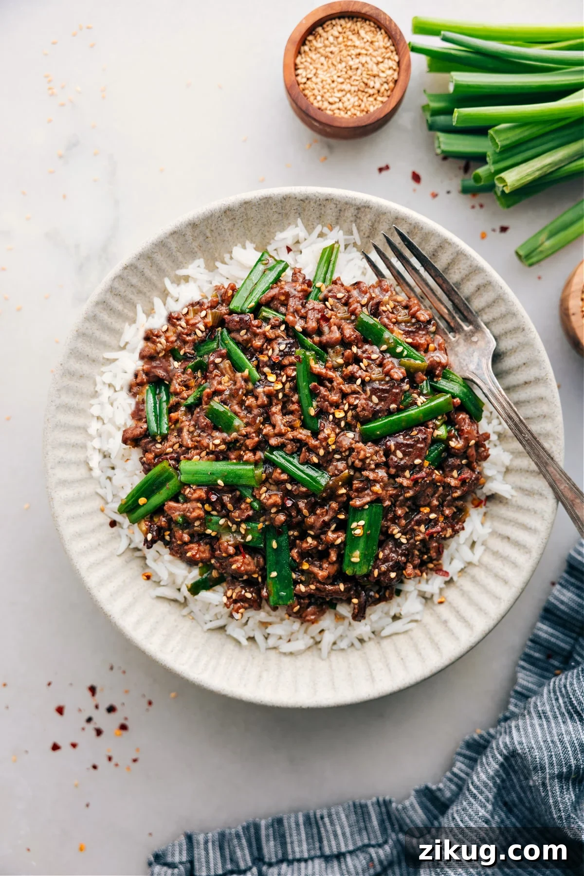 20-Minute Mongolian Ground Beef Mongolian ground beef in a skillet with green onions and savory stir fry sauce.