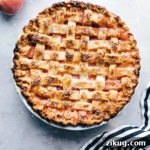 Fresh Peach Pie with Flaky Buttery Crust 9 Delicious and sweet peach pie, fresh out of the oven and topped with sugar, accompanied by fresh peaches on the side.