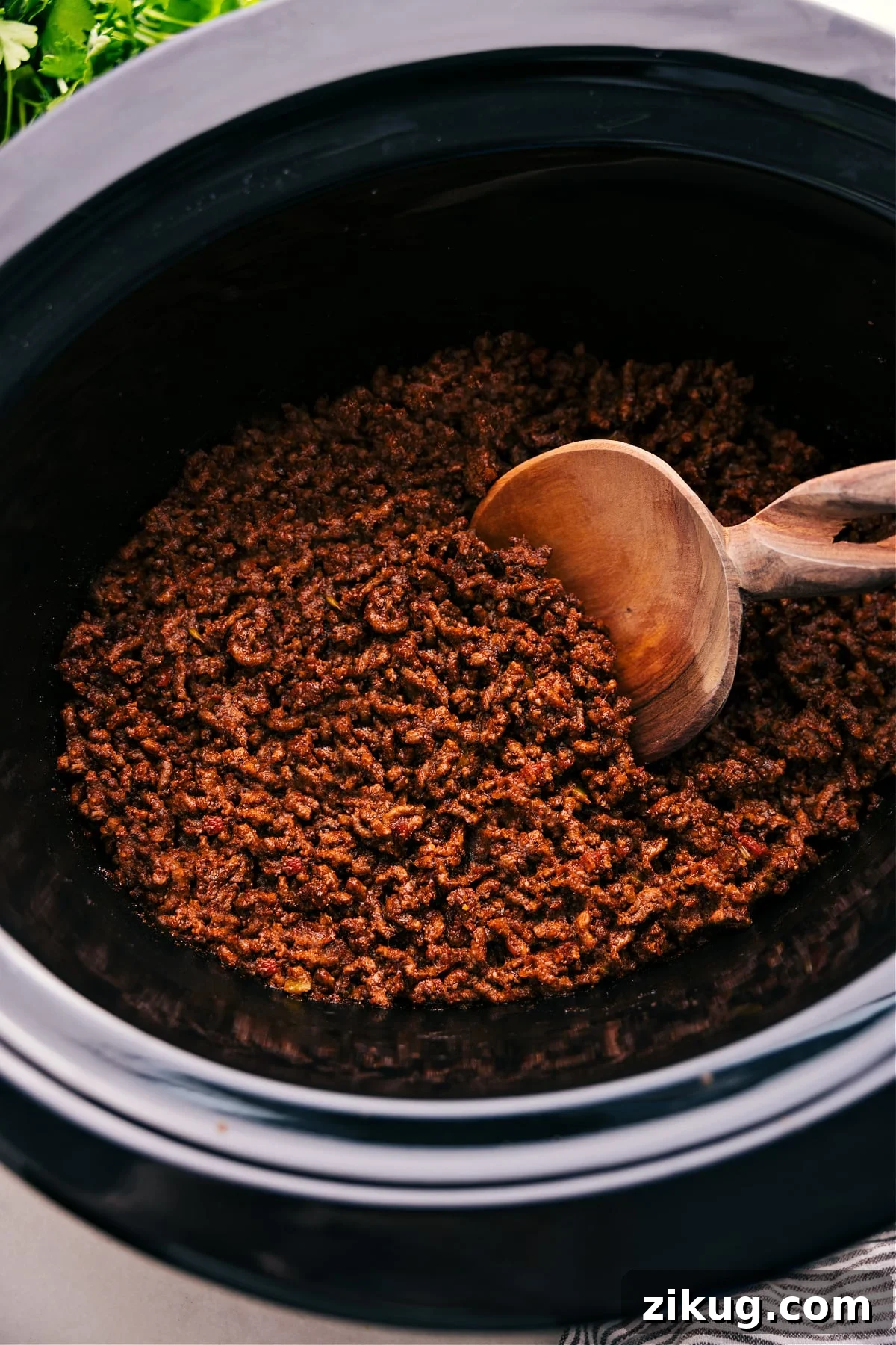 Crockpot Taco Meat Tender seasoned taco meat cooking in a slow cooker for a simple family meal.