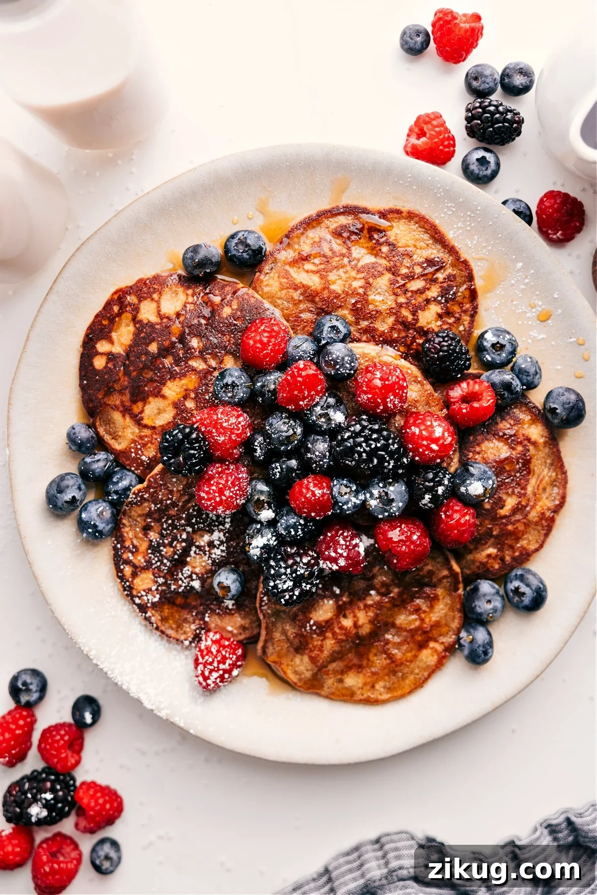 Healthy Pancake Recipe Fluffy healthy pancakes with golden edges served with fresh berries and maple syrup.