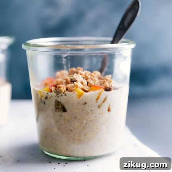 Make-Ahead Chocolate Peanut Butter Overnight Oats 7 Peach overnight oats in a bowl, ready to be eaten, topped with fresh peach slices and crunchy granola.